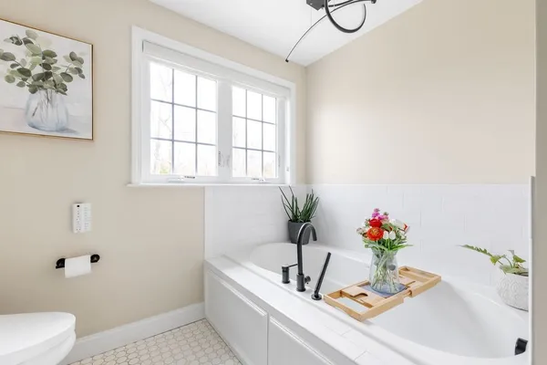 a bath tub sitting next to a white sink