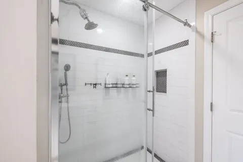a bathroom with a glass shower door