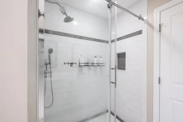 a bathroom with a glass shower door