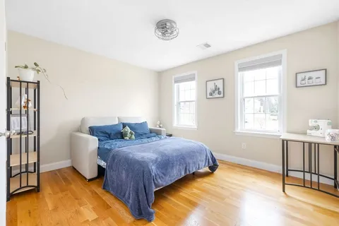 a bedroom with bed and a window