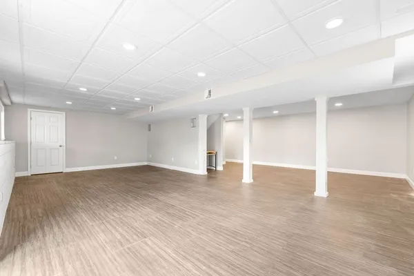 a view of an empty room with wooden floor