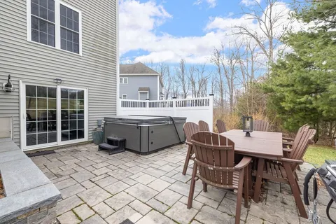 a table and chairs sitting in front of a house