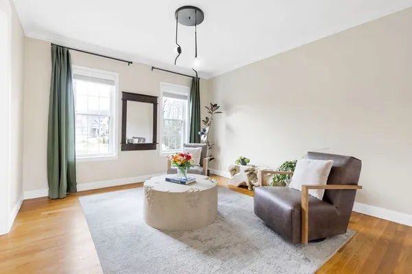a living room with furniture and wooden floor