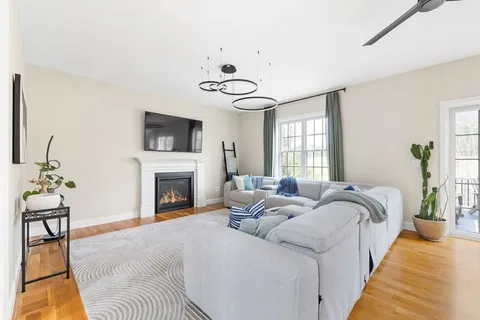 a living room with furniture fireplace and window