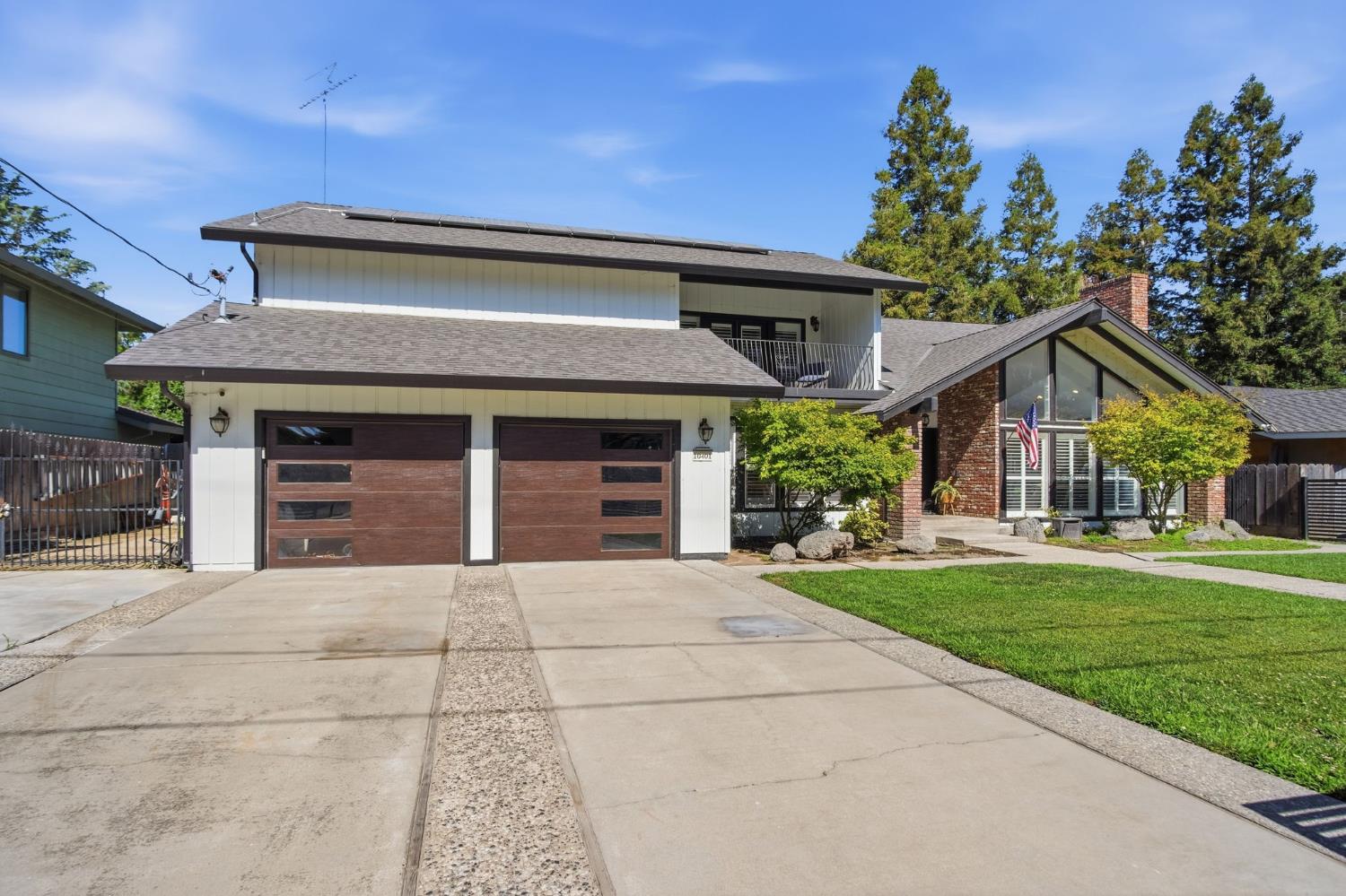 10401 Golf Link Road Turlock, CA 95380 - Photo 4 of 63 a front view of a house with a garden and trees