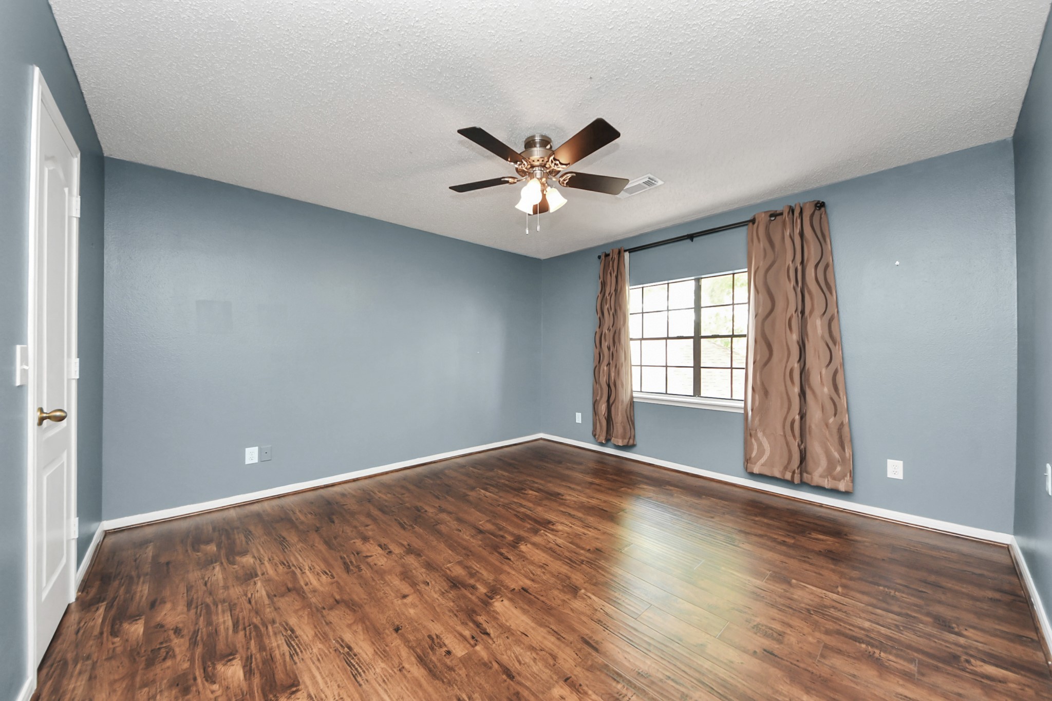 3107 Dulaney Road Houston, TX 77084 - Photo 37 of 50 wooden floor in an empty room with a window