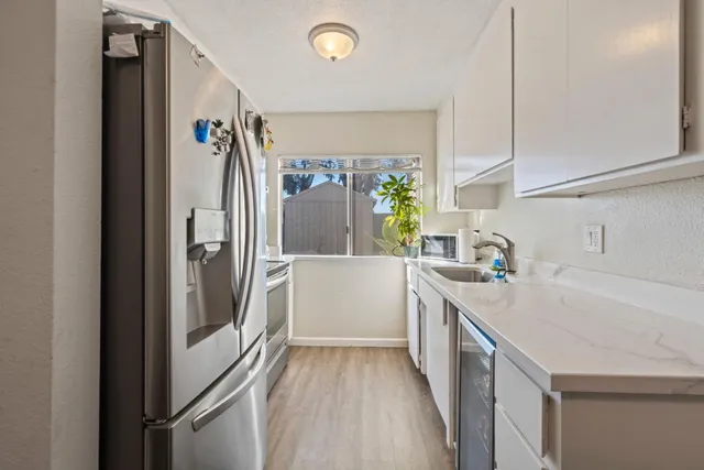 a kitchen with a sink a refrigerator and a stove