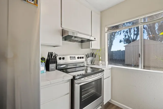 a kitchen with stainless steel appliances a stove and a refrigerator