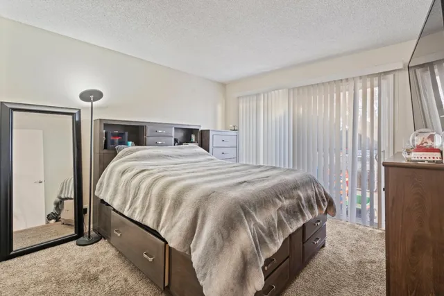a bed sitting in a bedroom next to a window