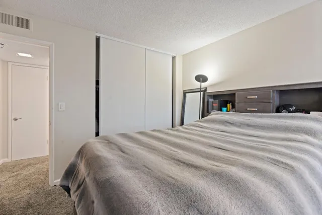 a bedroom with a bed and a lamp