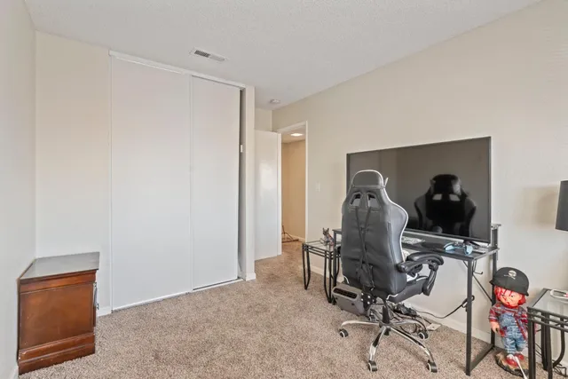 a view of a workspace with furniture and gym equipment