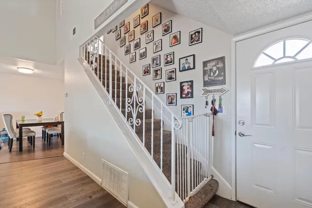 a view of entryway and hall with wooden floor