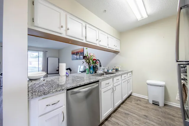 a kitchen with stainless steel appliances granite countertop a sink stove and cabinets