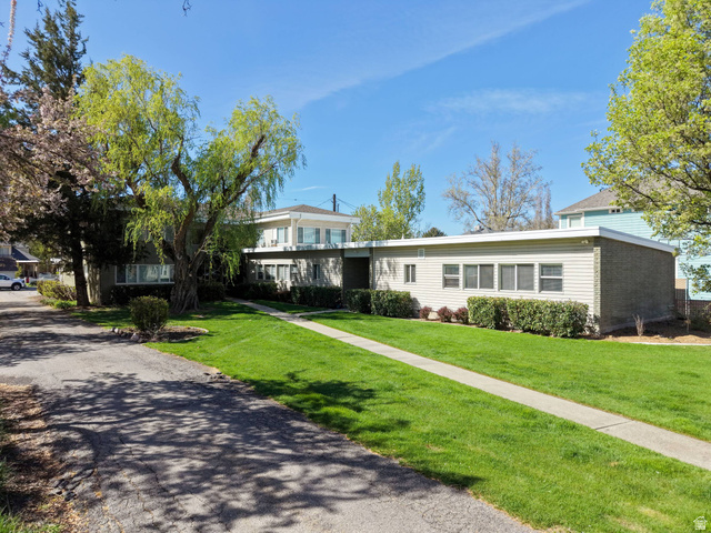 550 100 North Provo, UT 84606 - Photo 2 of 7 Expansive front yard featuring a verdant lawn, mature trees, and established shrubbery