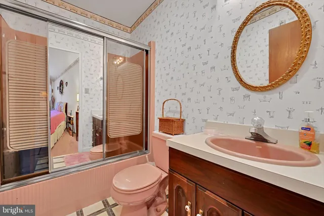 a spacious bedroom with a bed and a dresser in it