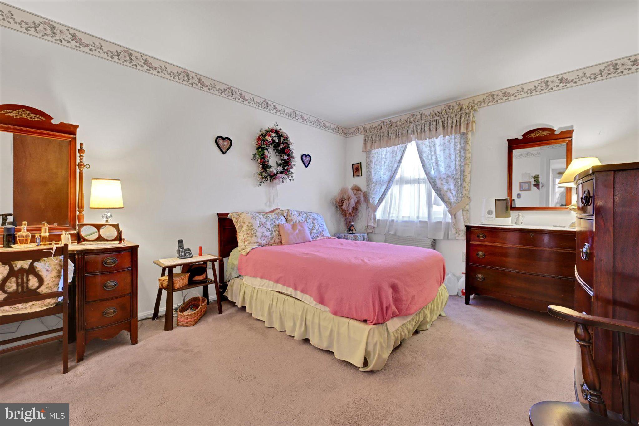 1334 West Wyomissing Court, Unit Q West Lawn, PA 19609 - Photo 18 of 25 a spacious bedroom with a bed and a dresser in it