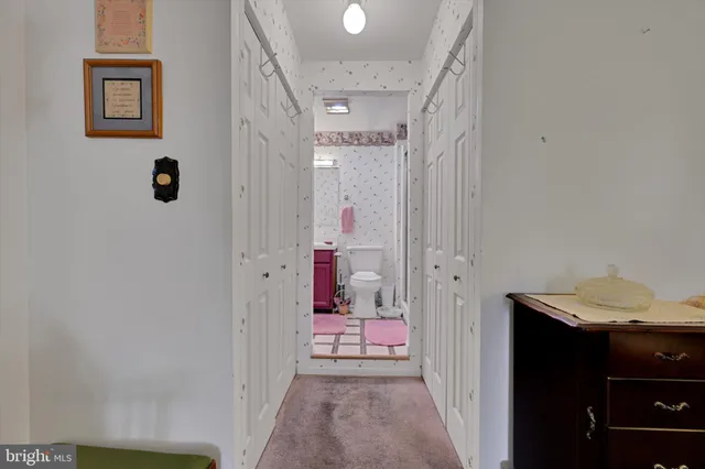 a bathroom with a granite countertop toilet sink and mirror