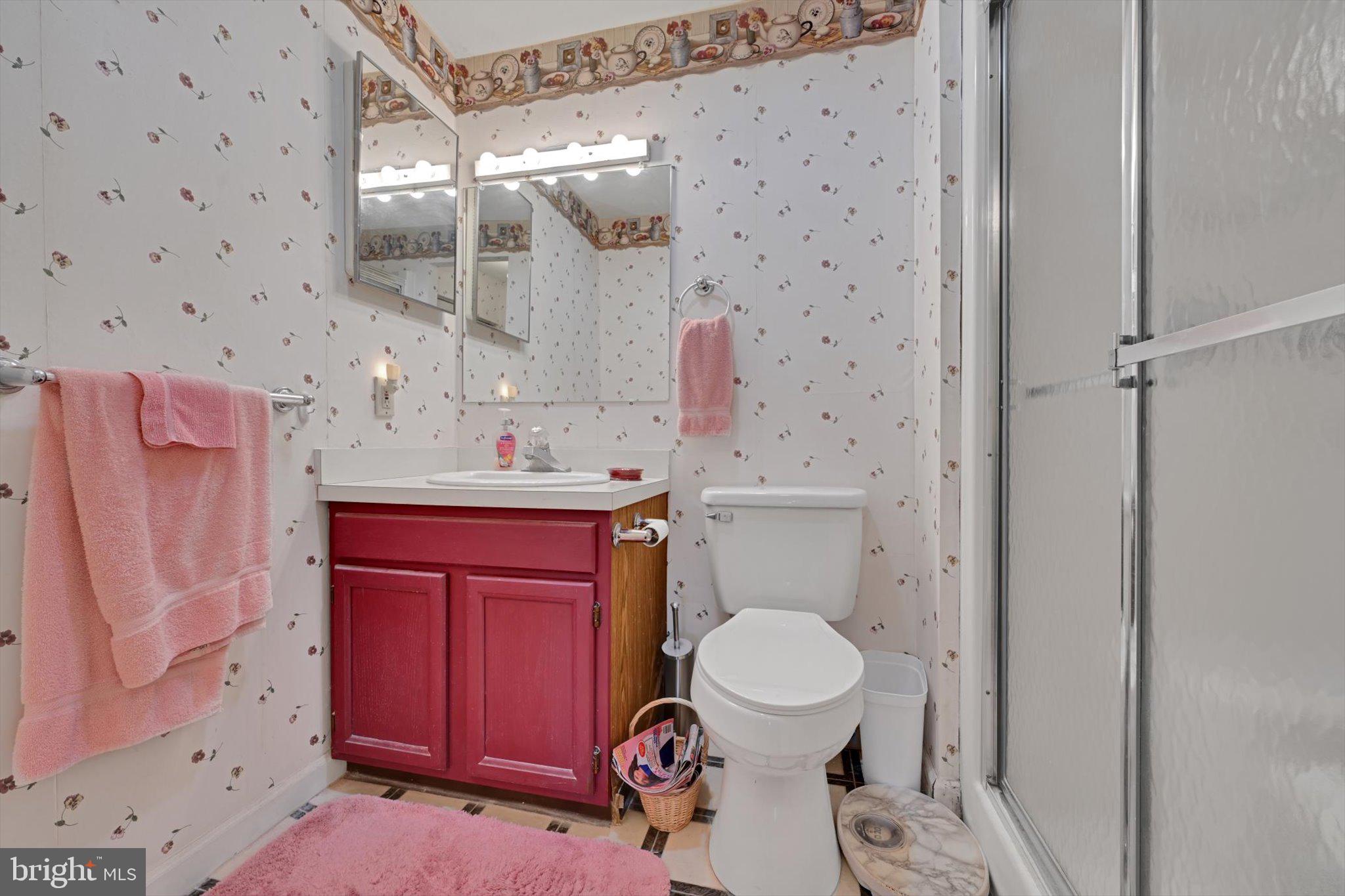 1334 West Wyomissing Court, Unit Q West Lawn, PA 19609 - Photo 22 of 25 a bathroom with a granite countertop toilet sink and mirror