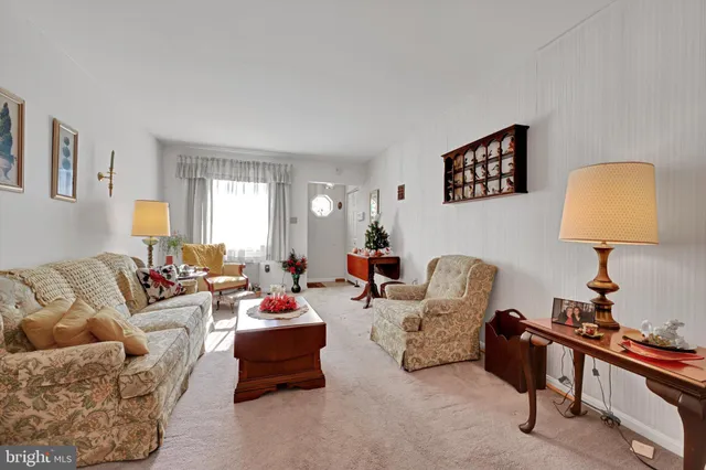 a living room with furniture a lamp and a window