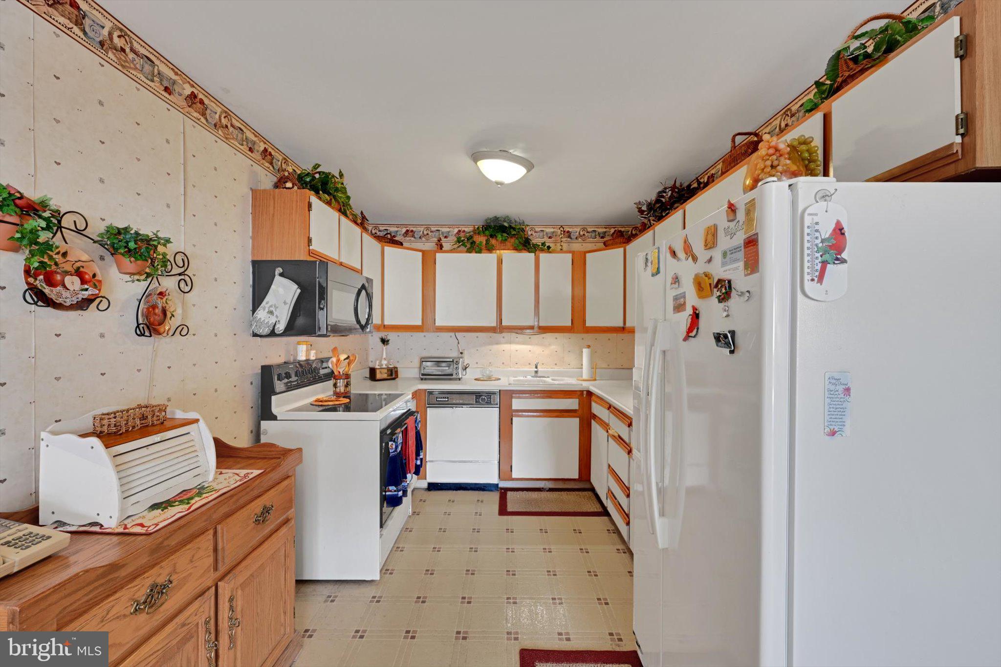 1334 West Wyomissing Court, Unit Q West Lawn, PA 19609 - Photo 6 of 25 a kitchen with stainless steel appliances granite countertop a refrigerator and a stove top oven