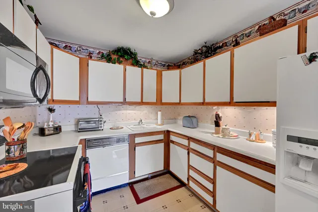 a kitchen with a sink cabinets and appliances