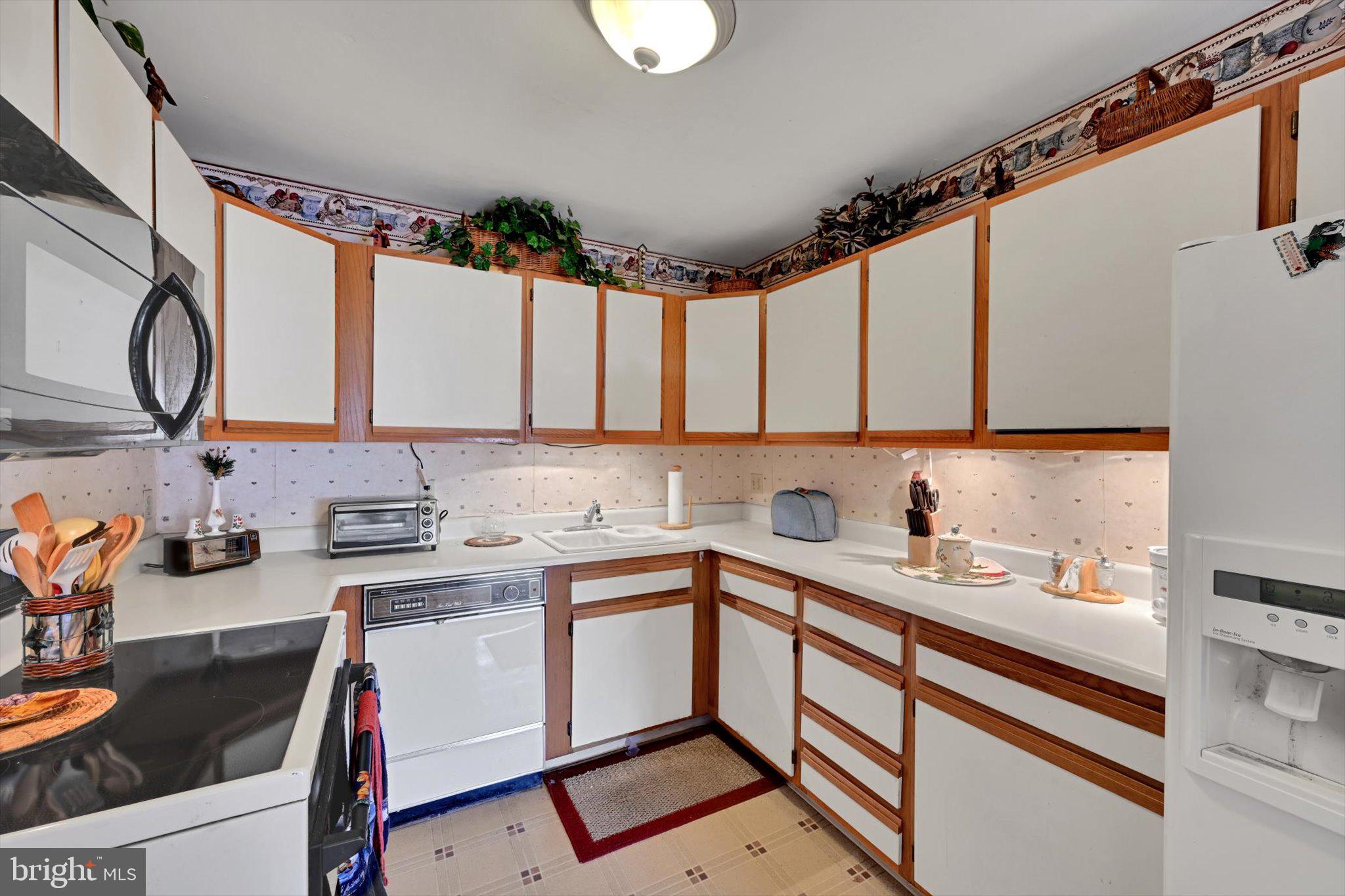1334 West Wyomissing Court, Unit Q West Lawn, PA 19609 - Photo 7 of 25 a kitchen with a sink cabinets and appliances