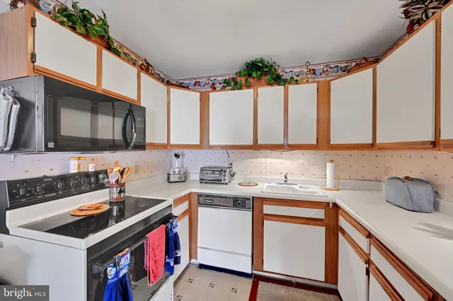 a kitchen that has a sink and a stove in it