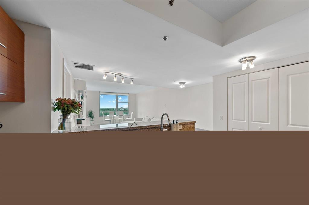 2641 North Flamingo Road Fort Lauderdale, FL 33323 - Photo 11 of 26 a living room with kitchen island granite countertop sink and cabinets