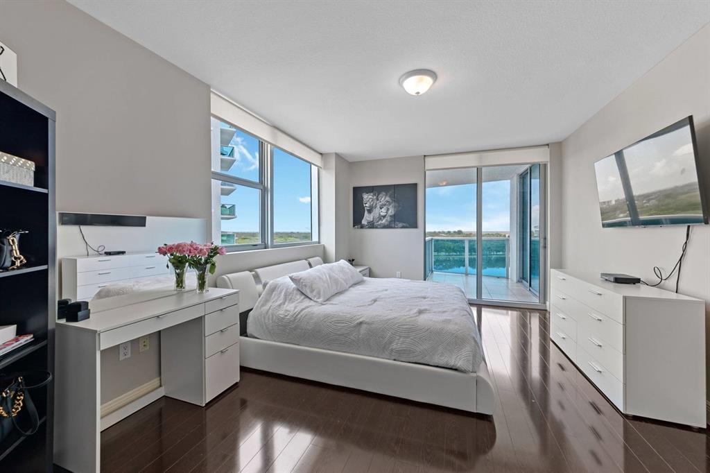 2641 North Flamingo Road Fort Lauderdale, FL 33323 - Photo 19 of 26 a bedroom with a bed and a flat tv screen on the dresser