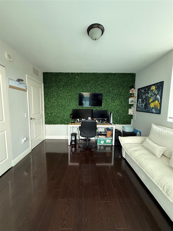 2641 North Flamingo Road Fort Lauderdale, FL 33323 - Photo 26 of 26 a living room with furniture and a flat screen tv