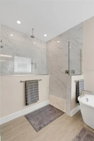 a bathroom with a bathtub and shower