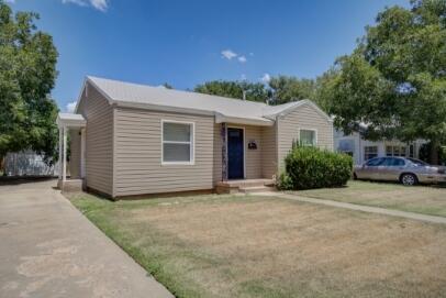 2320 26th Street Lubbock, TX 79411 - Photo 2 of 17 a front view of a house with a garden