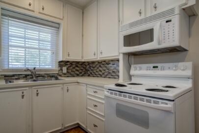 2320 26th Street Lubbock, TX 79411 - Photo 6 of 17 a kitchen with appliances a sink and cabinets