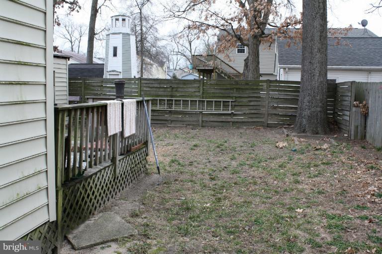 7830 A East Shore Road Pasadena, MD 21122 - Photo 4 of 6 a view of house with wooden fence