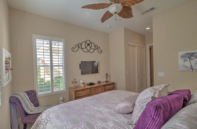a living room with furniture ceiling fan and a window