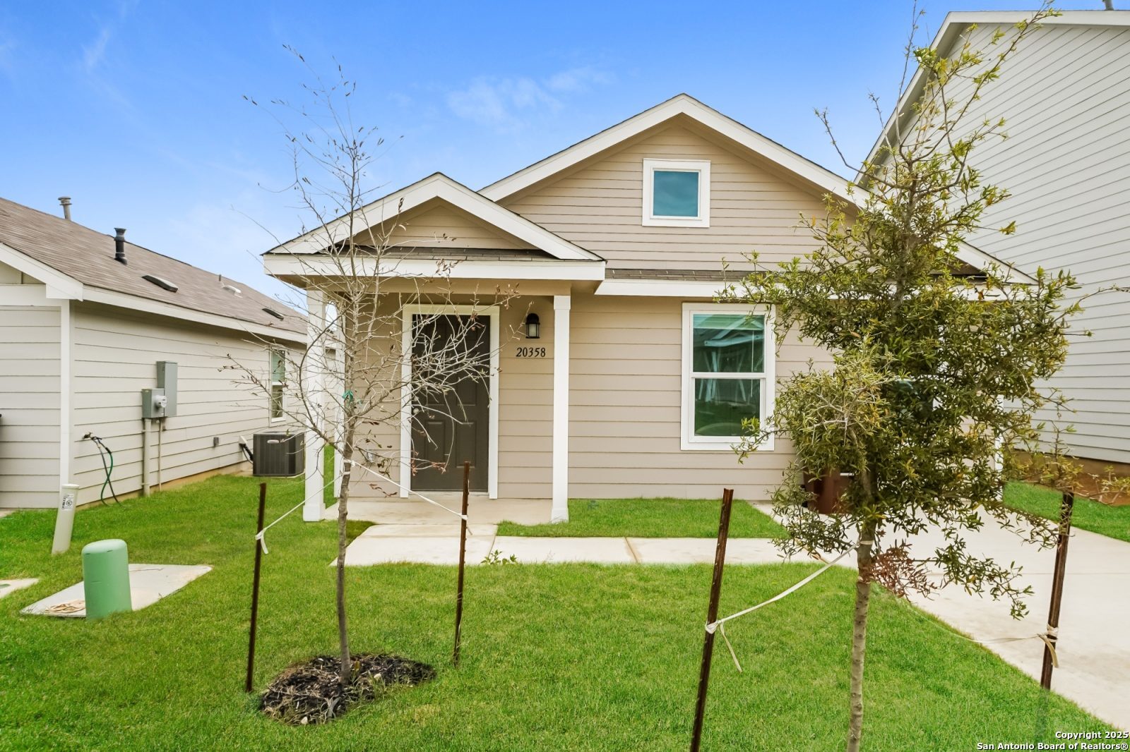 a view of a house with a yard and sitting area