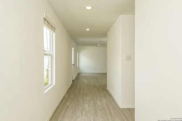 a view of a hallway with wooden floor