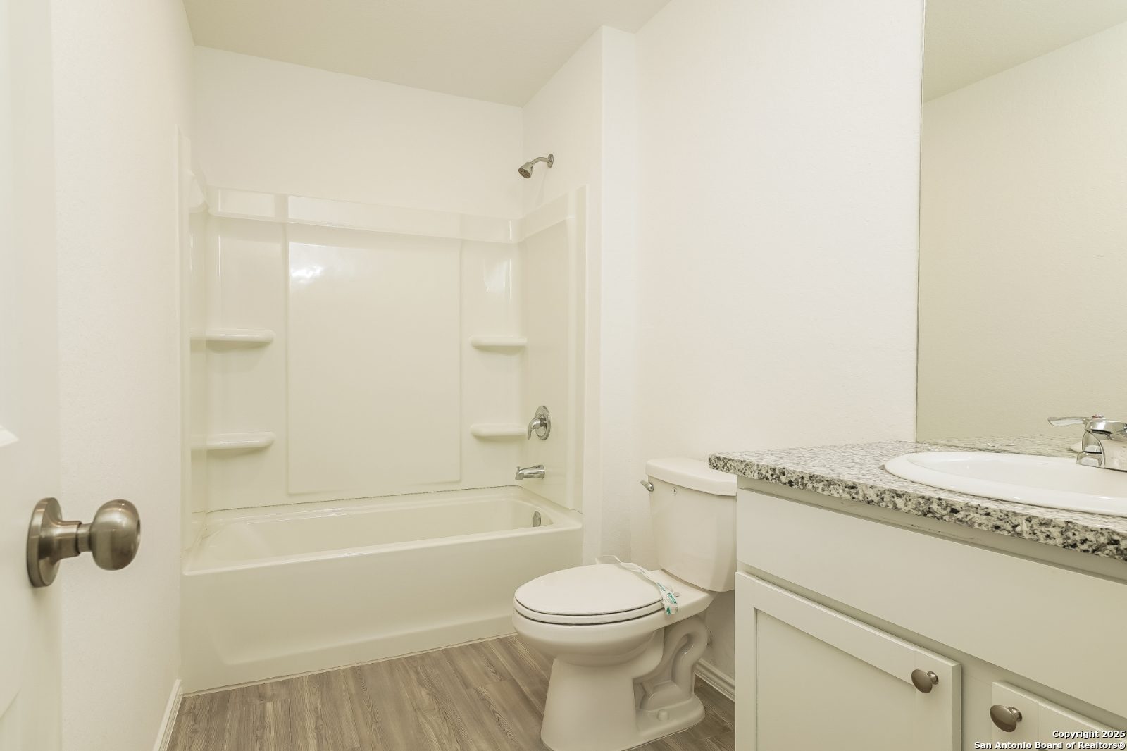 20358 Andesine Ridge San Antonio, TX 78264 - Photo 7 of 14 a bathroom with a granite countertop bathtub sink vanity mirror and toilet