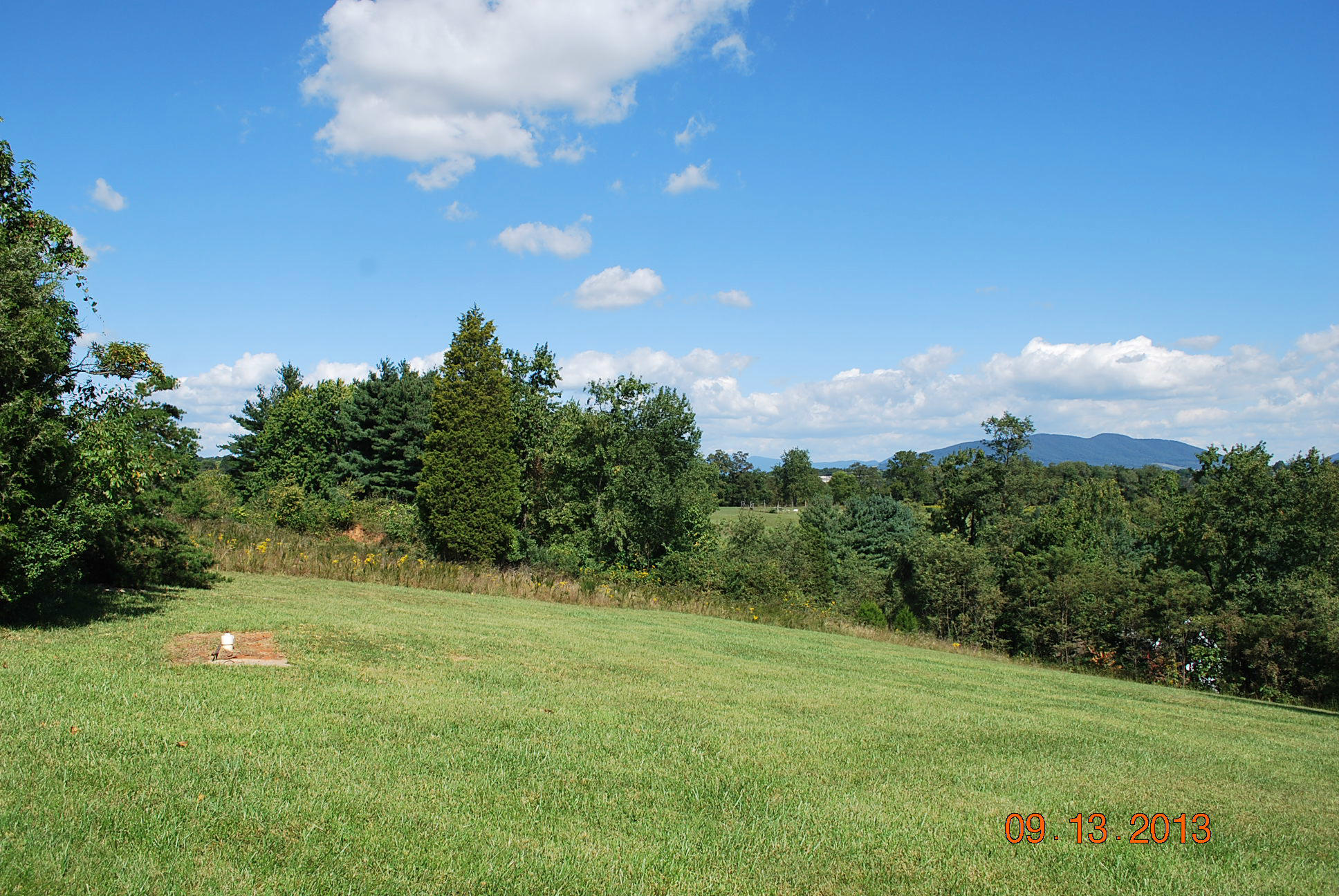 2777 Highland Road Roanoke, VA 24014 - Photo 34 of 56 a view of a grassy field with trees in the background