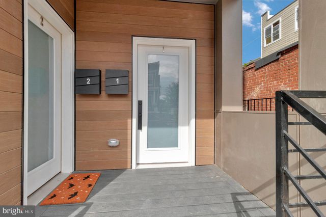 a view of a hallway with a door and stairs