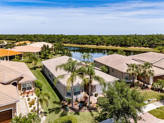 an aerial view of residential houses with outdoor space and swimming pool