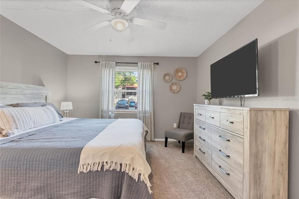 3239 South Beneva Road, Unit 101 Sarasota, FL 34232 - Photo 17 of 37 a bedroom with a bed and a flat screen tv
