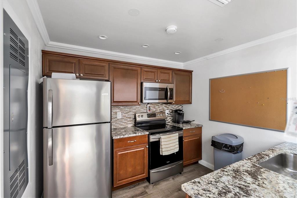 3239 South Beneva Road, Unit 101 Sarasota, FL 34232 - Photo 32 of 37 a kitchen with stainless steel appliances granite countertop a refrigerator a sink and a stove