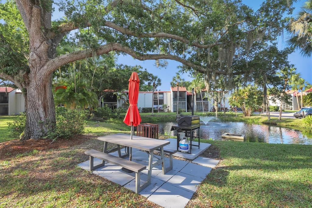 3239 South Beneva Road, Unit 101 Sarasota, FL 34232 - Photo 35 of 37 a table and chairs sitting in the garden