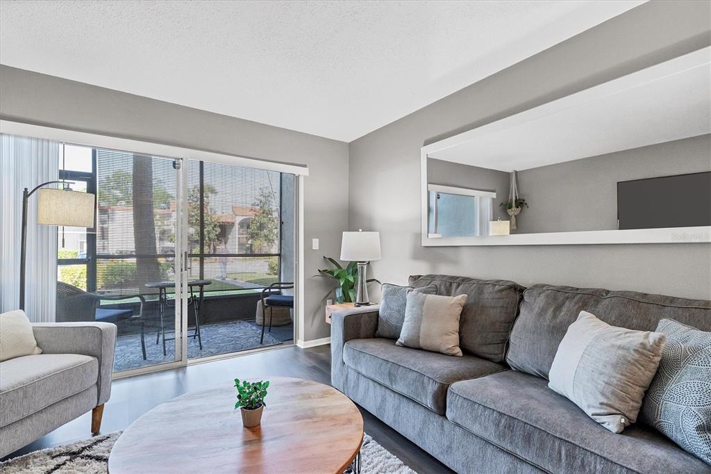 3239 South Beneva Road, Unit 101 Sarasota, FL 34232 - Photo 5 of 37 a living room with furniture and a large window