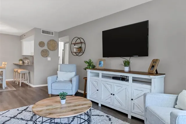 a view of a dining room with furniture and a potted plant