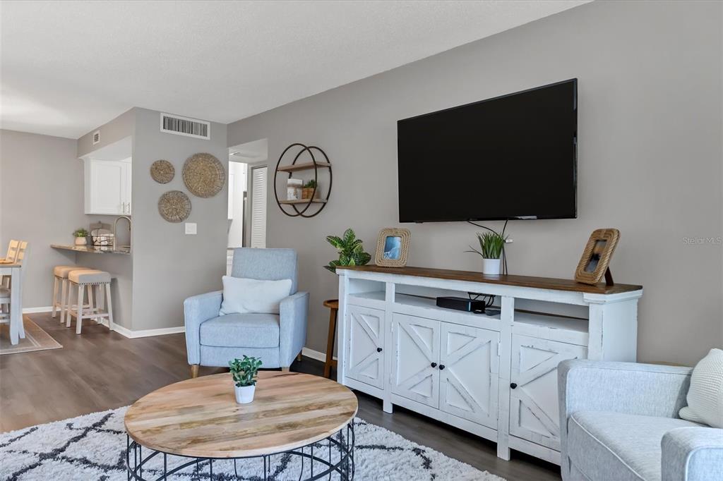 3239 South Beneva Road, Unit 101 Sarasota, FL 34232 - Photo 7 of 37 a living room with furniture and a flat screen tv
