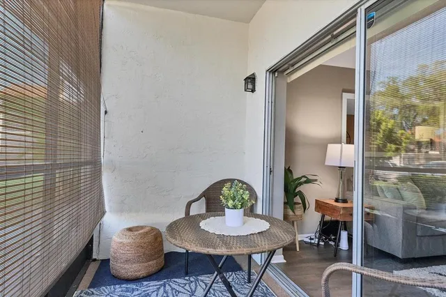 a dining room with furniture a potted plant and wooden floor