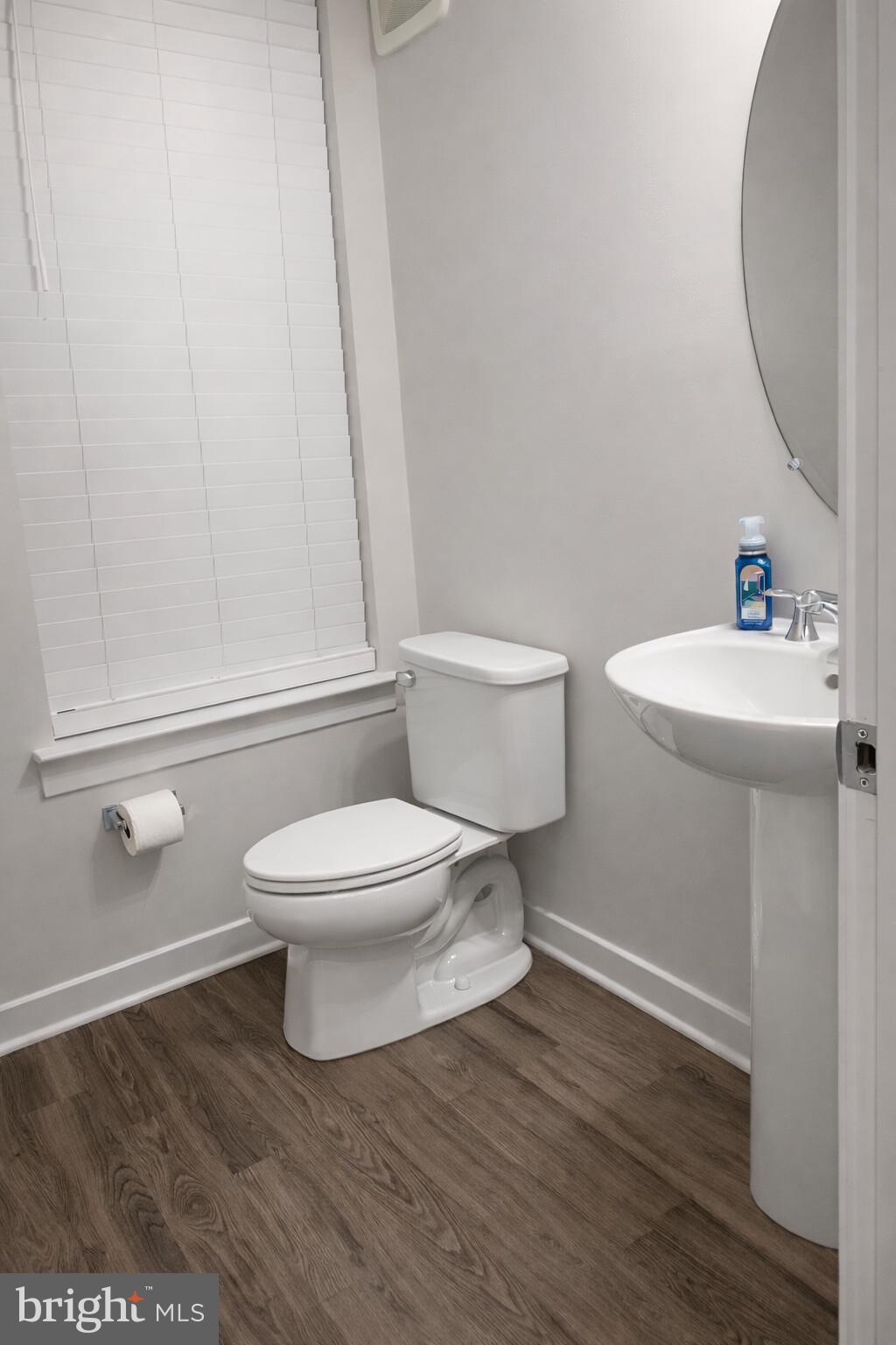 13695 Innovation Station Loop, Unit 77B Herndon, VA 20171 - Photo 11 of 11 a white toilet sitting next to a bathroom sink