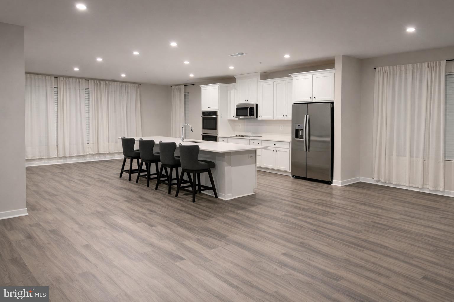 13695 Innovation Station Loop, Unit 77B Herndon, VA 20171 - Photo 4 of 11 a kitchen with stainless steel appliances a refrigerator and a dining table